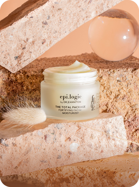Toples moisturizer epi.logic terbuka di antara balok batu — brand skincare di Shopify